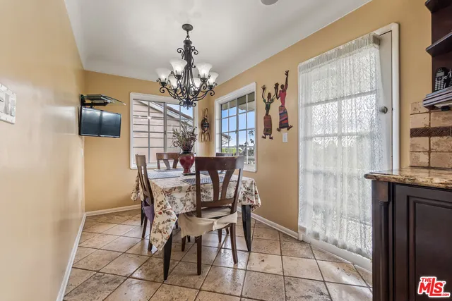 a view of a dining room with furniture and a chandelier