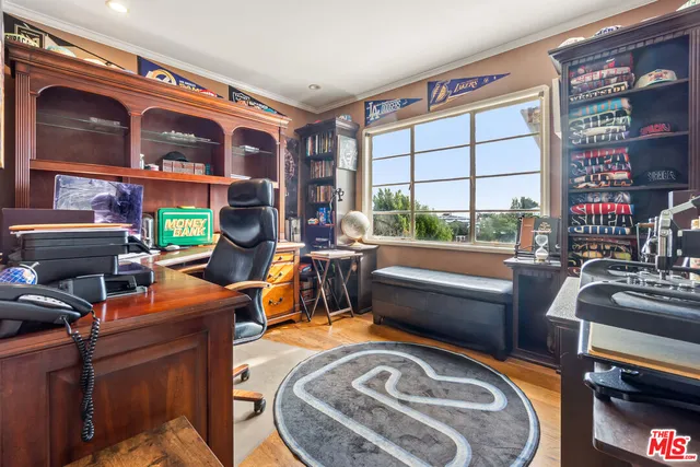 a living room with furniture a bookshelf and a large window