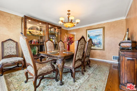 a view of a dining room with furniture wooden floor and chandelier