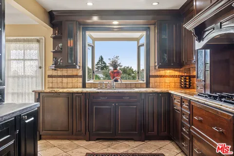 a kitchen with stainless steel appliances a sink stove and cabinets