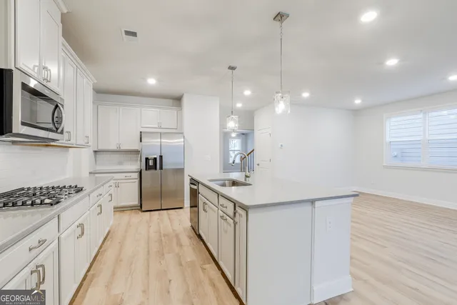 a kitchen with stove cabinets and wooden floor