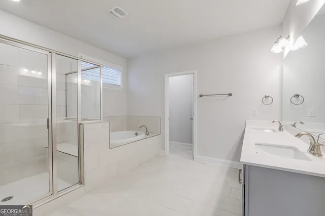 a bathroom with a tub sink and mirror