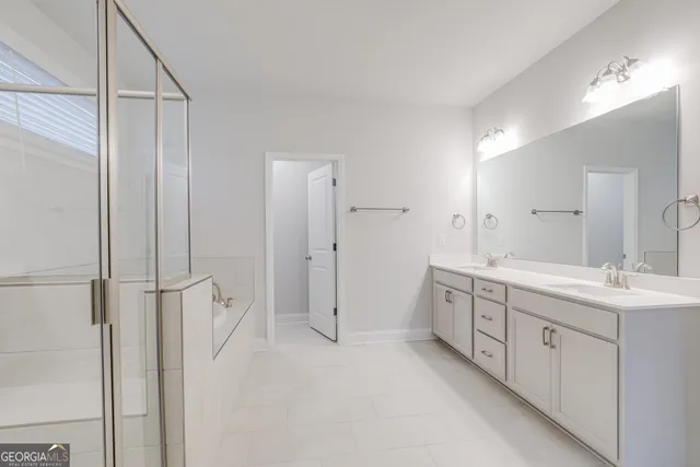 a bathroom with a double vanity sink toilet and shower
