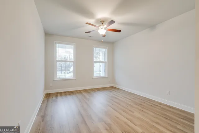 wooden floor in an empty room with a window