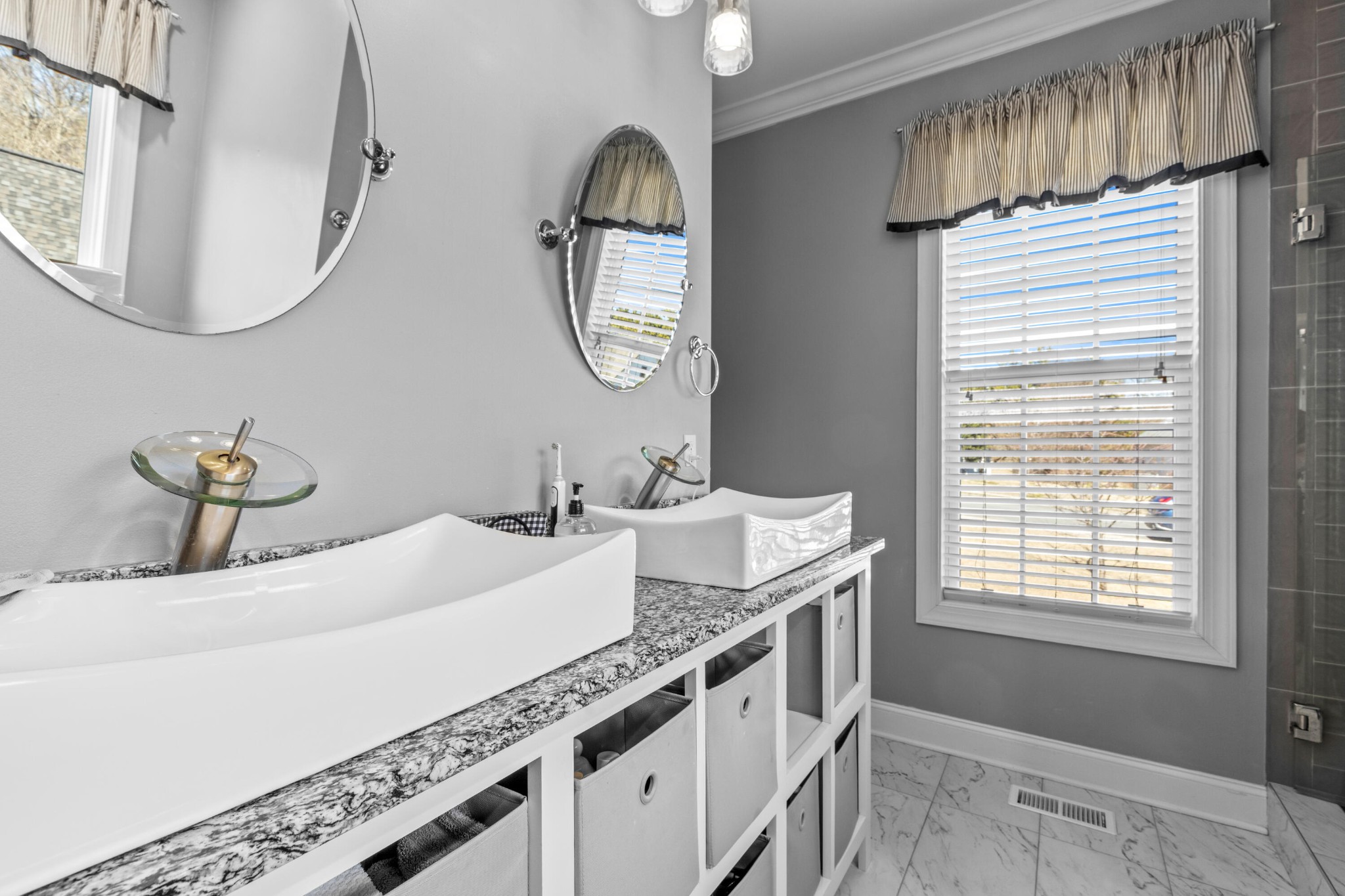 59 Honeysuckle Drive Rock Spring, GA 30739 - Photo 18 of 63 a bathroom with a double vanity sink and a mirror