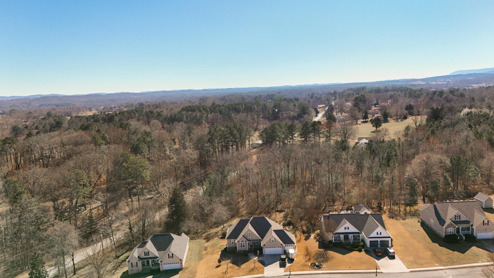 59 Honeysuckle Drive Rock Spring, GA 30739 - Photo 2 of 63 an aerial view of a house with a yard and mountain view