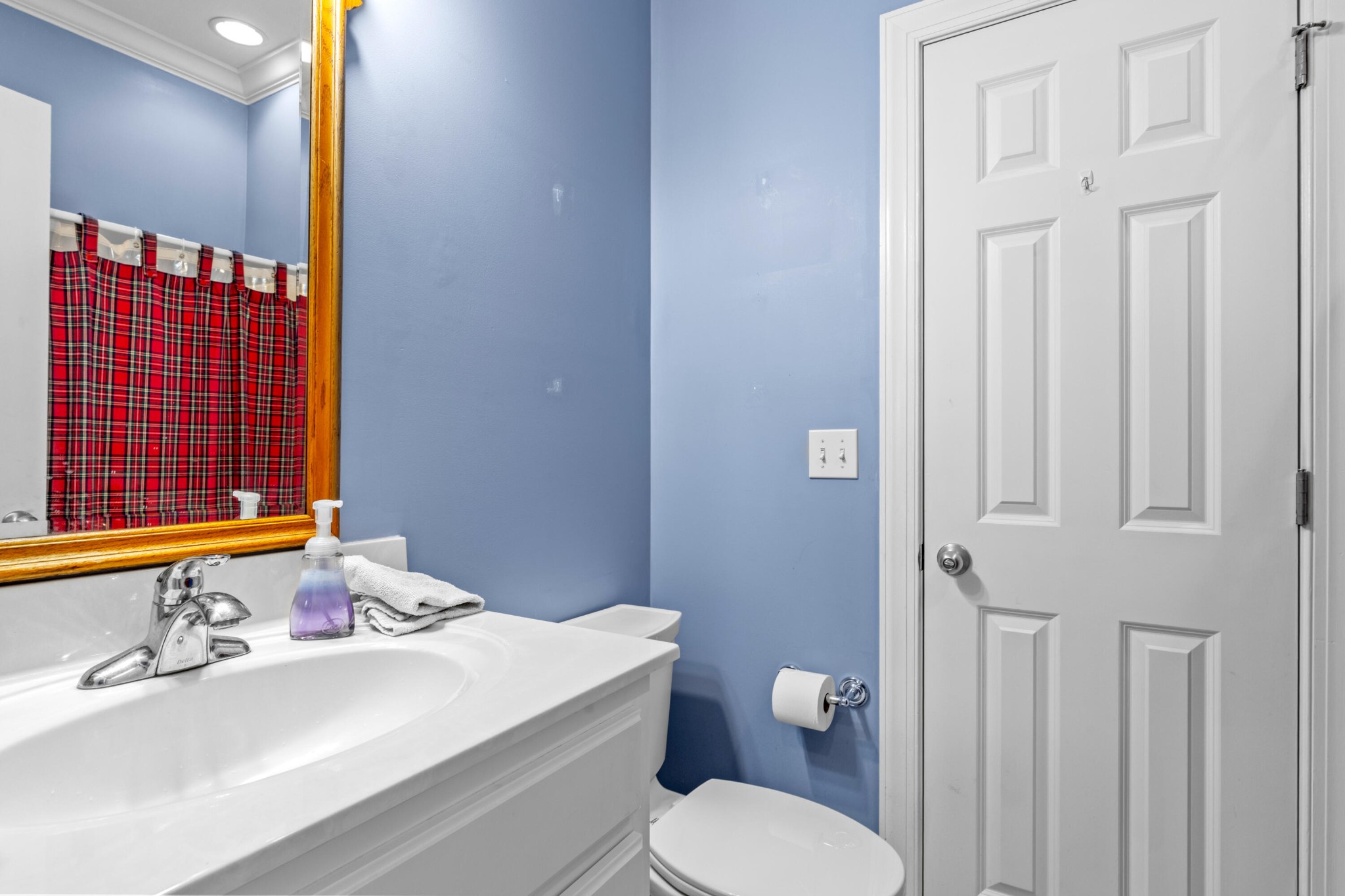 59 Honeysuckle Drive Rock Spring, GA 30739 - Photo 24 of 63 a bathroom with a sink a toilet and shower curtain