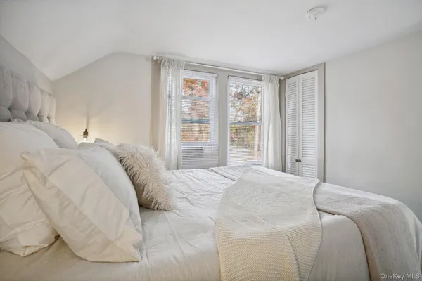 a bedroom with a large bed and a large window