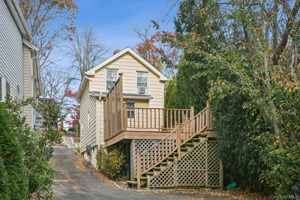 a view of a house with a wooden deck