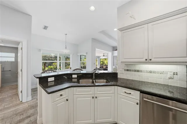 a kitchen with a sink and cabinets