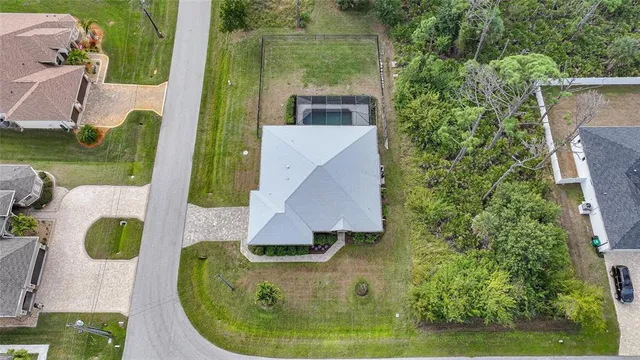 an aerial view of a house with swimming pool garden and patio