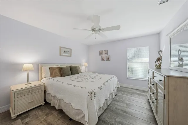 a bathroom with a granite countertop double vanity sink mirror and shower