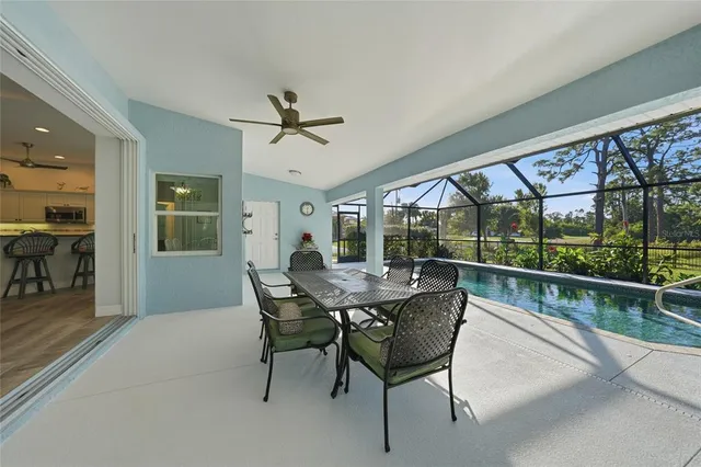 a view of a porch with furniture and backyard