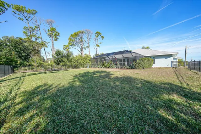 an aerial view of residential houses with outdoor space and swimming pool