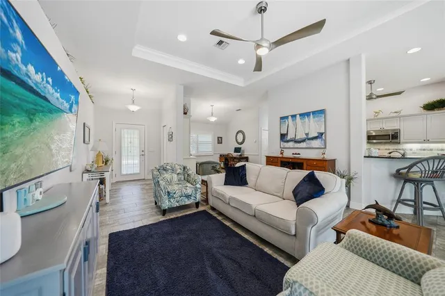 a living room with furniture and a chandelier