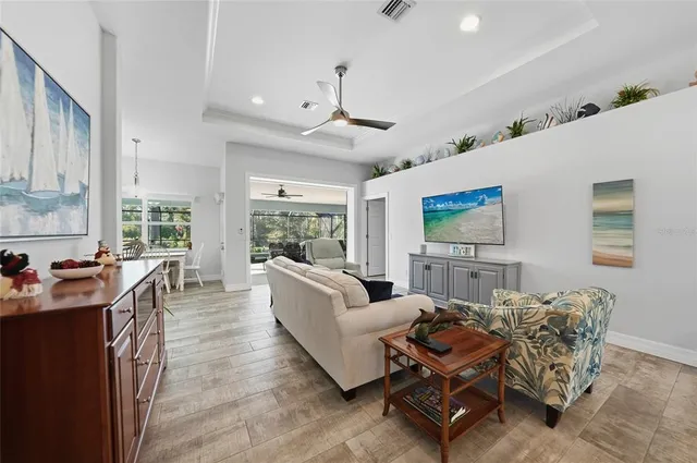 a living room with furniture a large window and a table