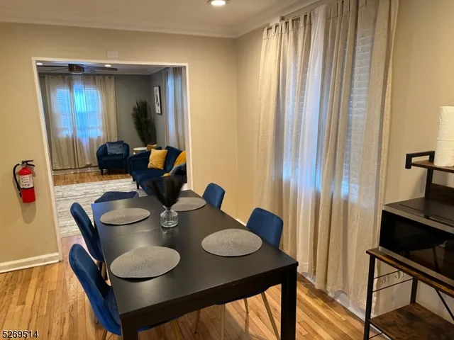 a dining room with furniture and wooden floor