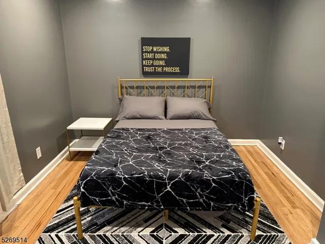 a bed sitting in a bedroom next to a window