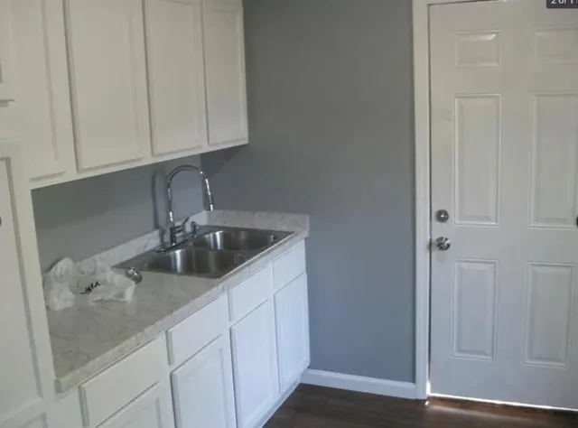 a kitchen with a sink and cabinets