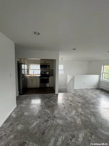 a view of a kitchen with furniture and cabinets