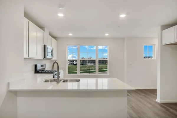 a kitchen with a sink and a large window