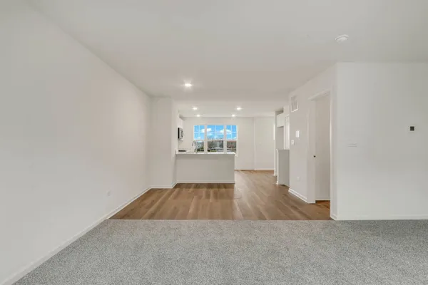 a living room with a couch and wooden floor