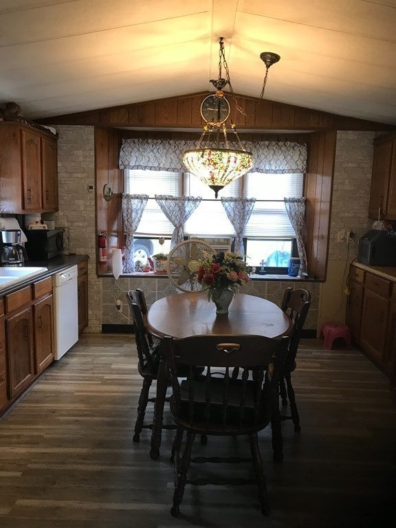 48 Gould Road Ware, MA 01082 - Photo 19 of 37 a kitchen with a dining table chairs and granite counter tops