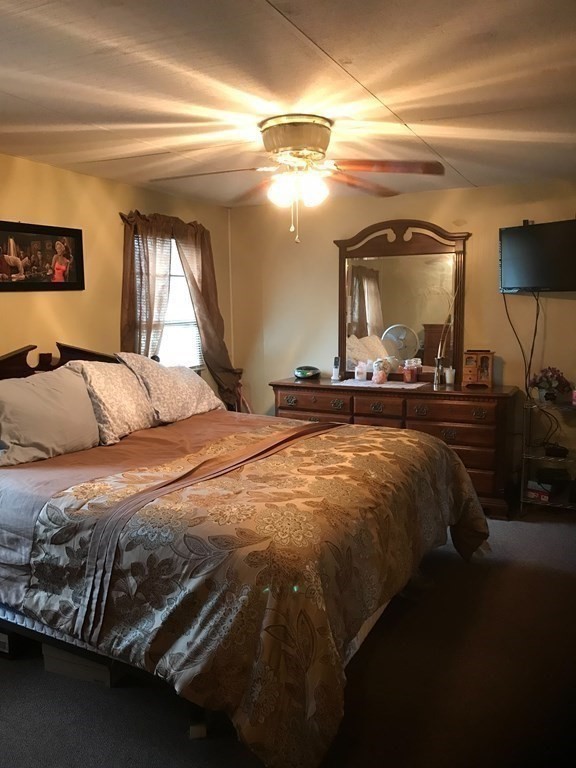 48 Gould Road Ware, MA 01082 - Photo 21 of 37 a bedroom with a bed and a large mirror on the dresser