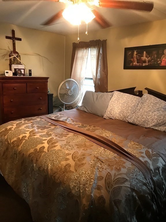 48 Gould Road Ware, MA 01082 - Photo 22 of 37 a bed sitting in a bedroom next to a lamp