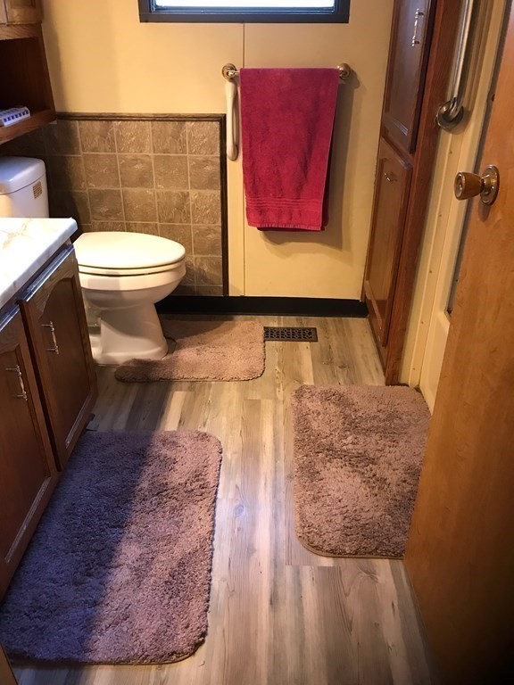 48 Gould Road Ware, MA 01082 - Photo 26 of 37 a bathroom with a toilet and a mirror