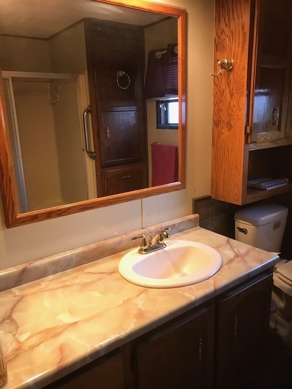 48 Gould Road Ware, MA 01082 - Photo 27 of 37 a bathroom with a sink and a mirror