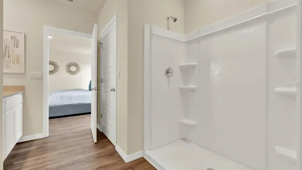 a bathroom with a tub shower and sink