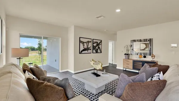a living room with furniture a rug and a table