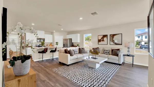 a living room with furniture or couch and a wooden floor