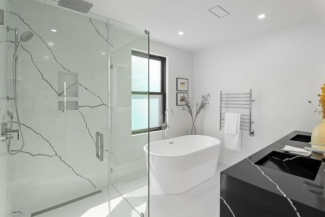 a bathroom with a sink a tub and a mirror