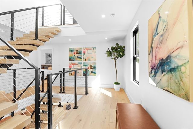 a bedroom with a bed and painting on the wall