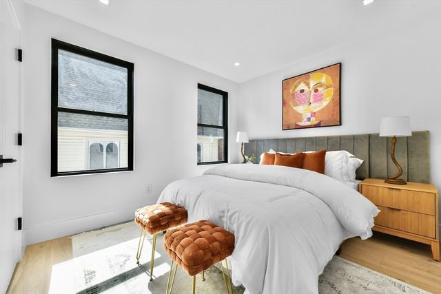 a bedroom with a bed and a painting on the wall