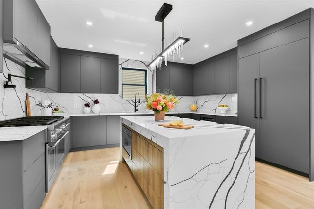 a kitchen that has a sink and a stove in it