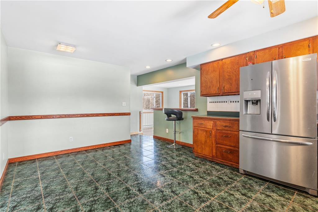 316 Noll Road Georgetown, PA 15043 - Photo 11 of 48 a kitchen with granite countertop a refrigerator and a stove top oven