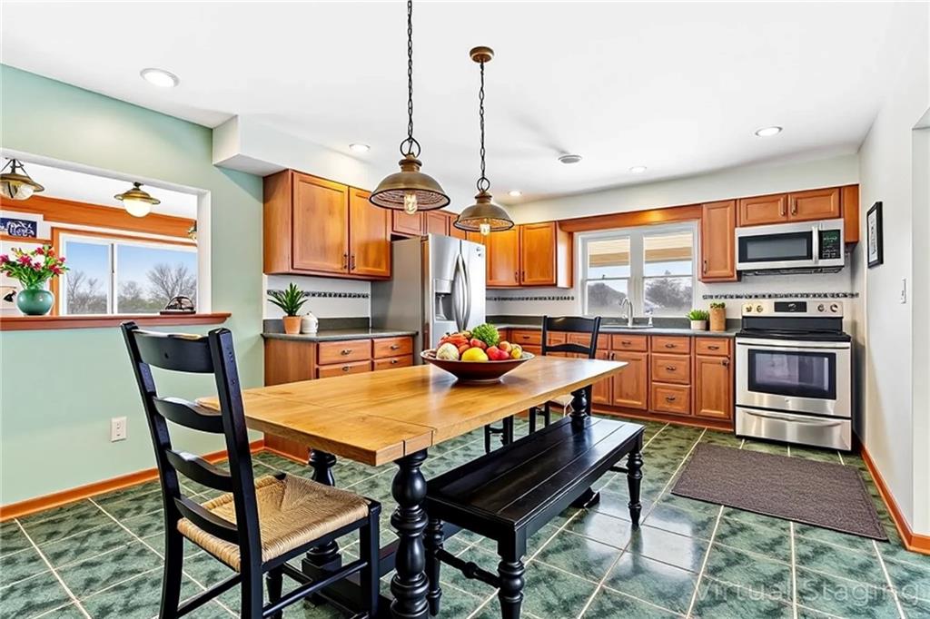 316 Noll Road Georgetown, PA 15043 - Photo 12 of 48 a outdoor kitchen with a stove a sink and a dining table with chairs