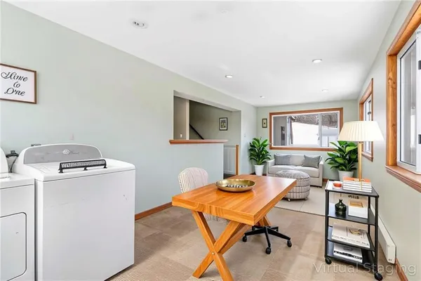 a view of a livingroom with furniture and a workspace