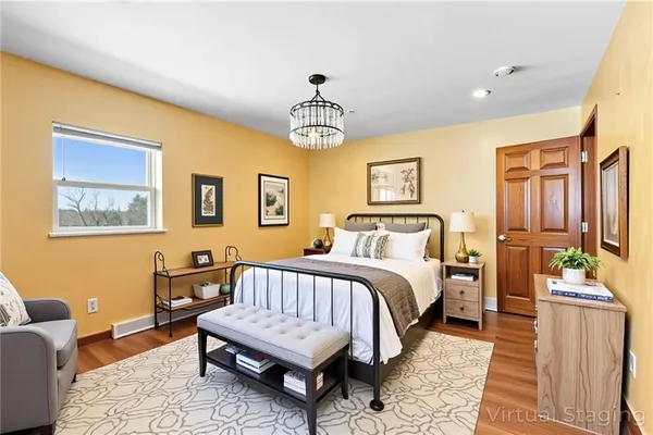 a bedroom with a bed a couch and dresser