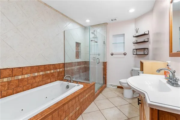 a bathroom with a tub sink and mirror