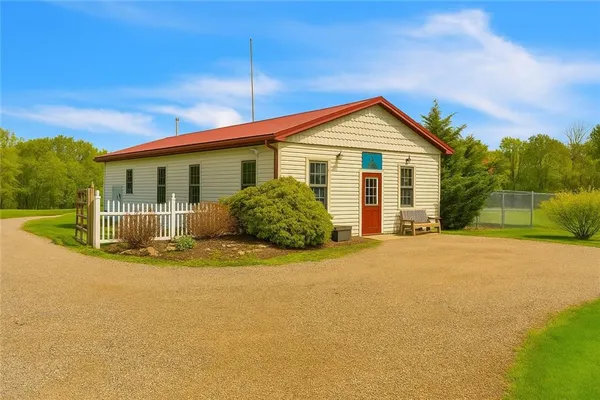 a view of a house with backyard and bushes