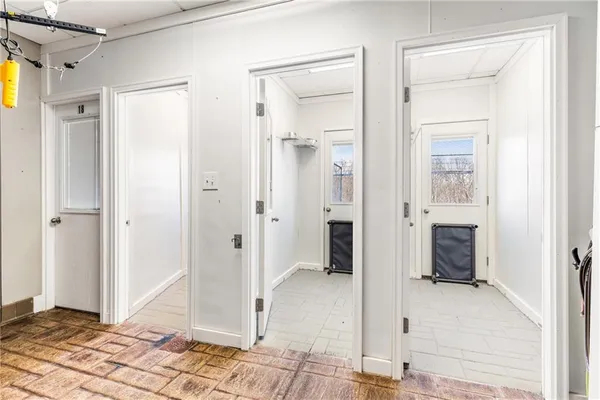a hallway with wooden floor and stairs