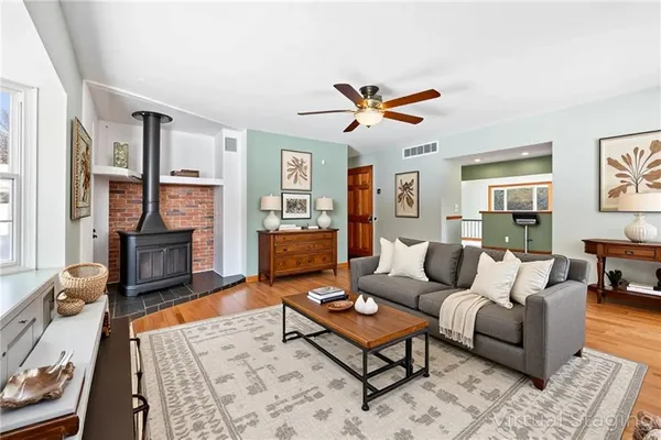 a living room with furniture a ceiling fan and a rug