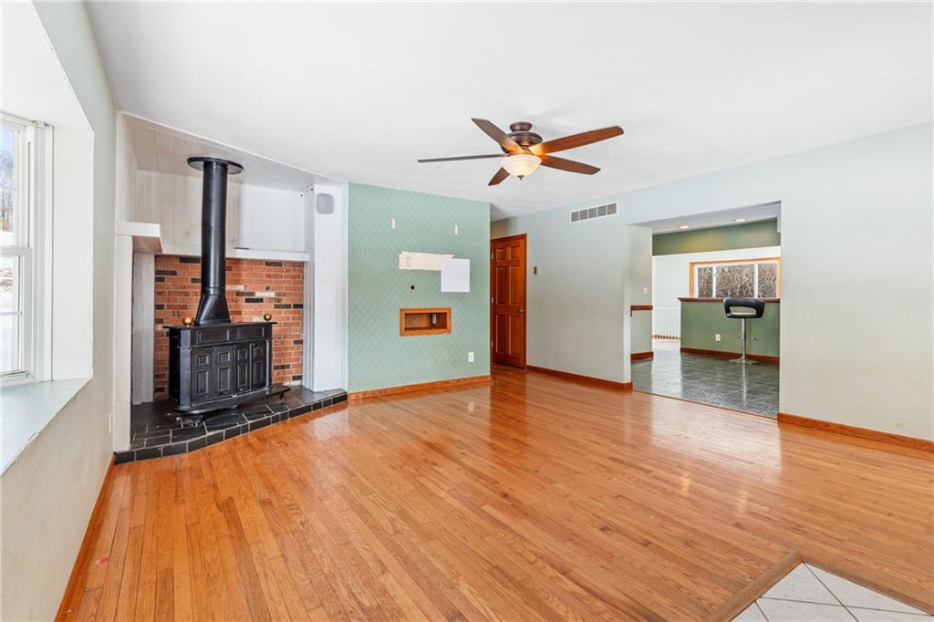 316 Noll Road Georgetown, PA 15043 - Photo 9 of 48 a view of an empty room with wooden floor and a ceiling fan