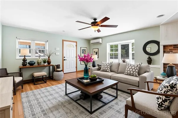 a living room with furniture a clock and a window