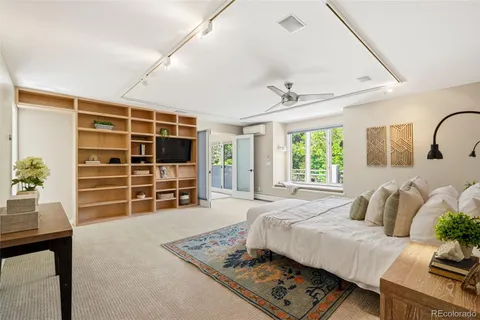 a bedroom with furniture and a flat screen tv