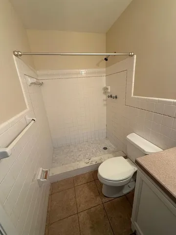 a bathroom with a toilet a sink and shower